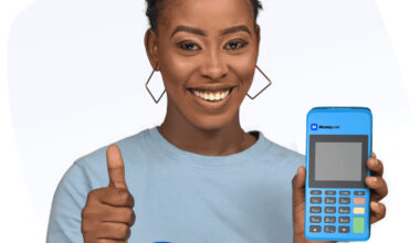 Moniepoint agent smiling with POS